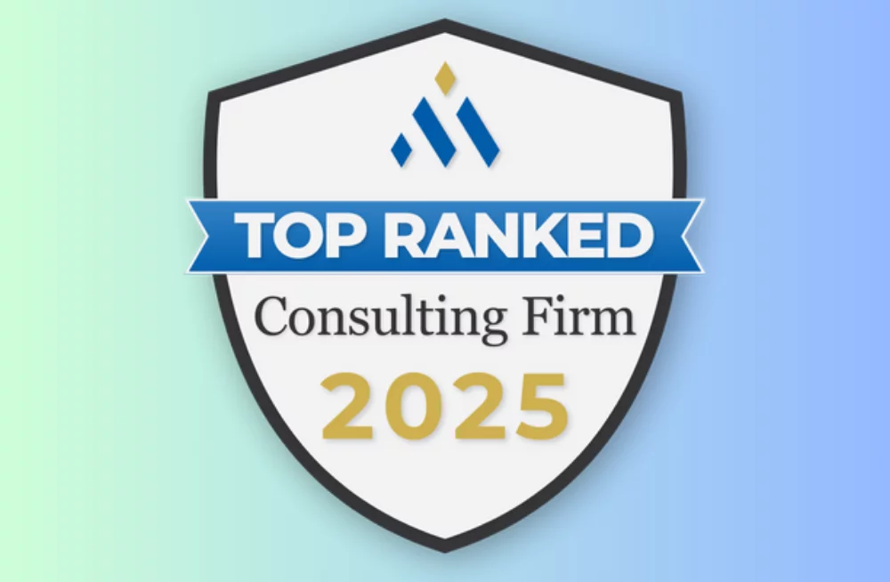 An award shield overlaying a blue-green gradient background. The shield reads: Top Ranke Consulting Firm 2025.